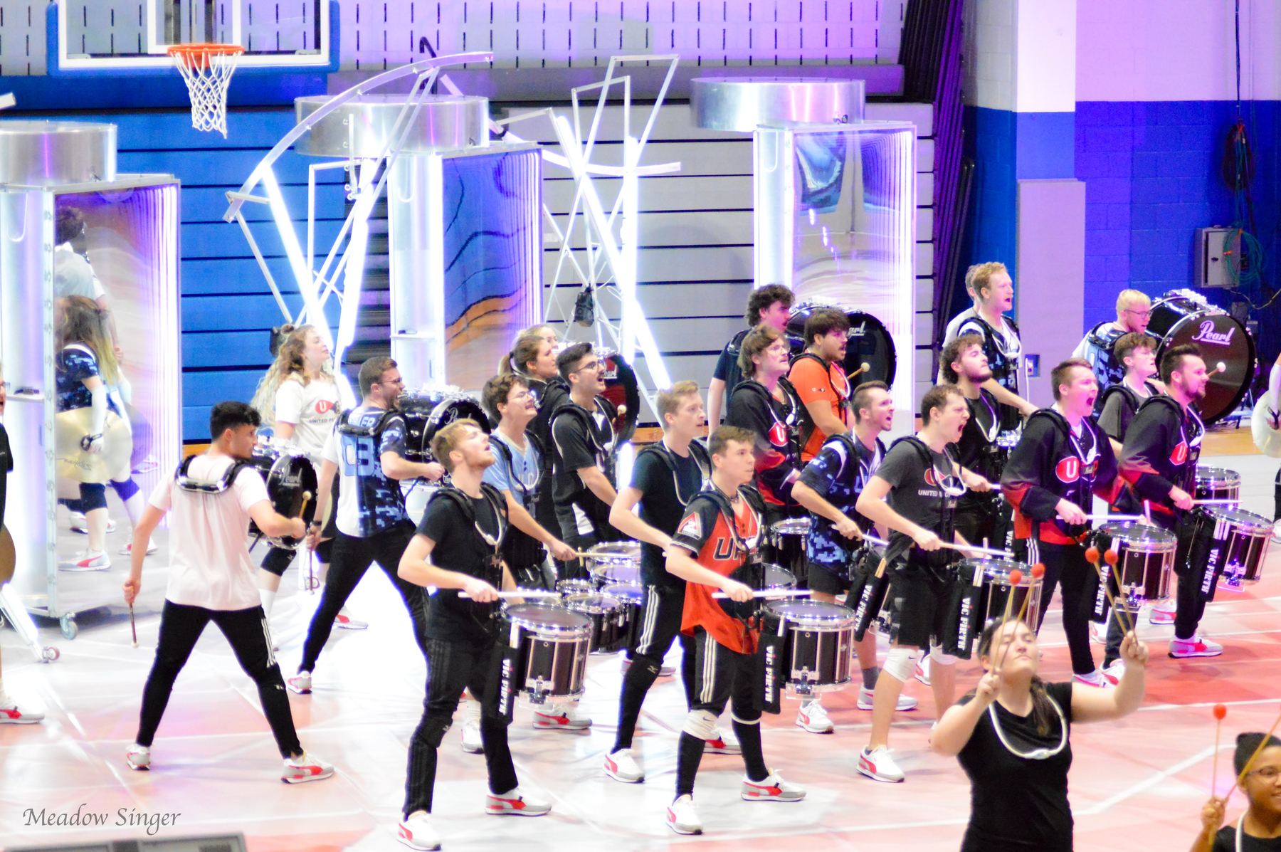 A full indoor drumline show on a gym floor
